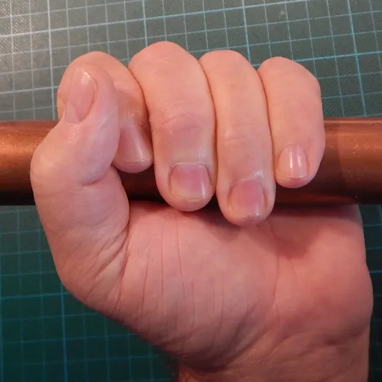 man holding a copper tube